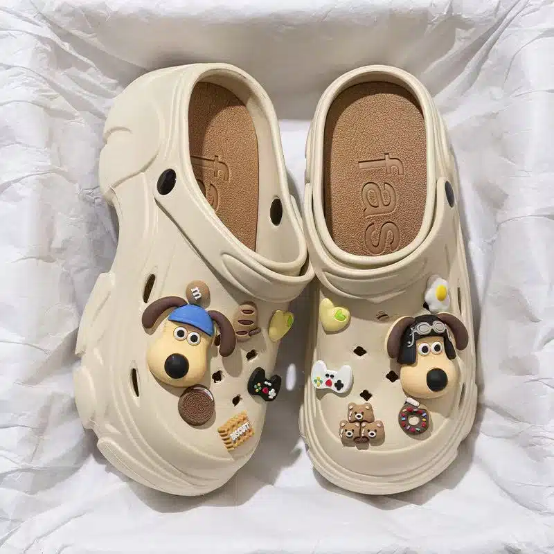 Step into fun with these playful charm clogs featuring dog faces, cookies, hearts, and tiny toys. Soft, stylish, and full of personality—perfect for daily wear or a quirky gift. Step into fun with these playful charm clogs featuring dog faces, cookies, hearts, and tiny toys. Soft, stylish, and full of personality—perfect for daily wear or a quirky gift.